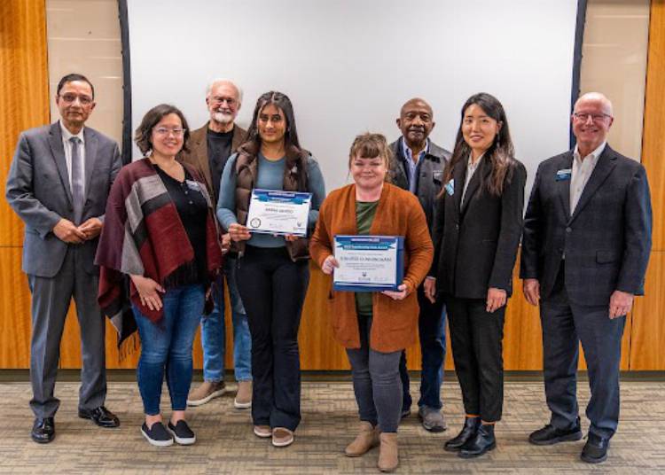 Two students receiving and award