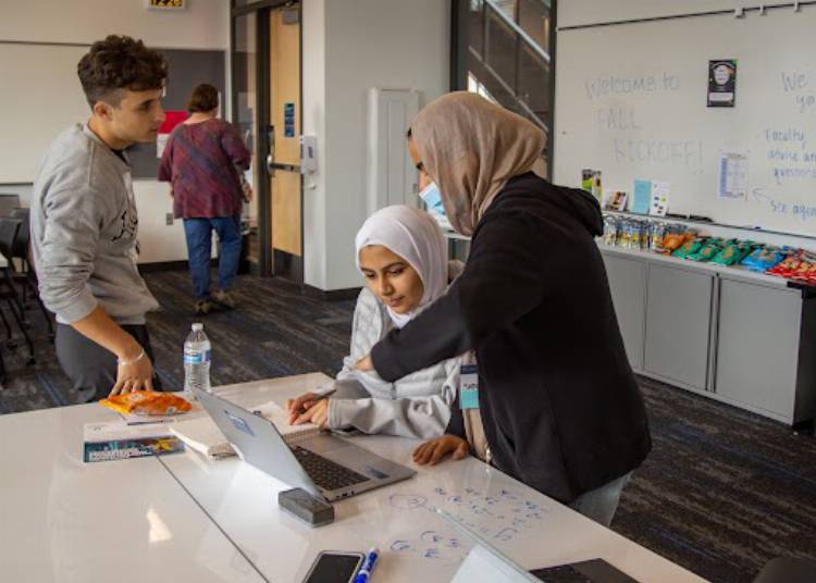 Student collaborating at a table