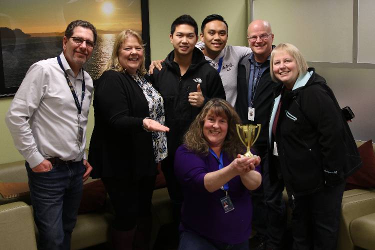 Left to right: Stewart Sinning, Edmonds CC food pantry program manager; Dr. Terry Cox; Toan Nguyen and Bryce Villanueva, IT support technicians; Thame Fuller, director of Nourishing Network programs; and Eva Smith, executive director of IT and e-learning. Bottom: Rita Smart, IT support technician. Credit: Edmonds Community College