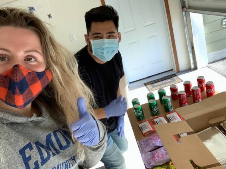 Edmonds College Resident Assistants Courtney Rigby and Murad Dweekat pass out meals to EC students in college housing who are experiencing food insecurity during COVID-19.
