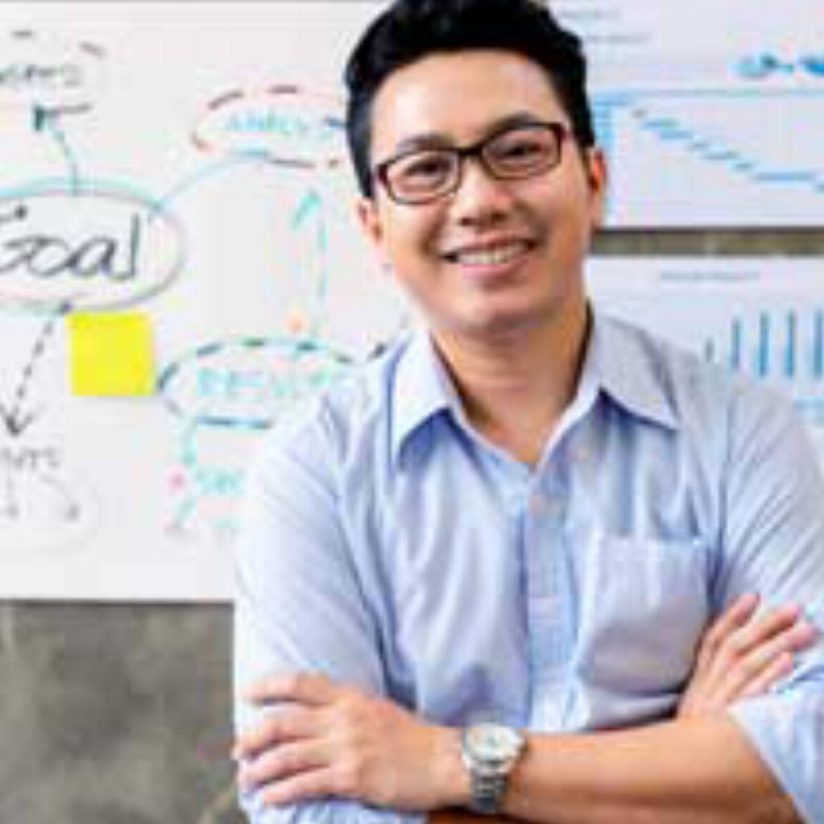 man standing in front of a white board