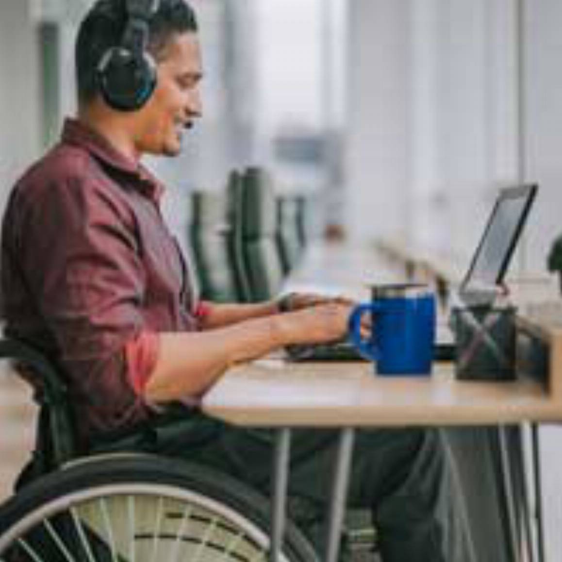 man on wheelchair working on a laptop