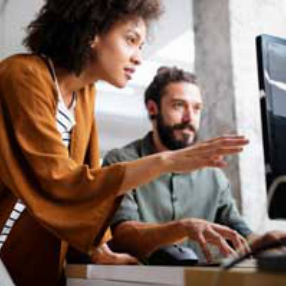 Man and woman looking at a computer screen