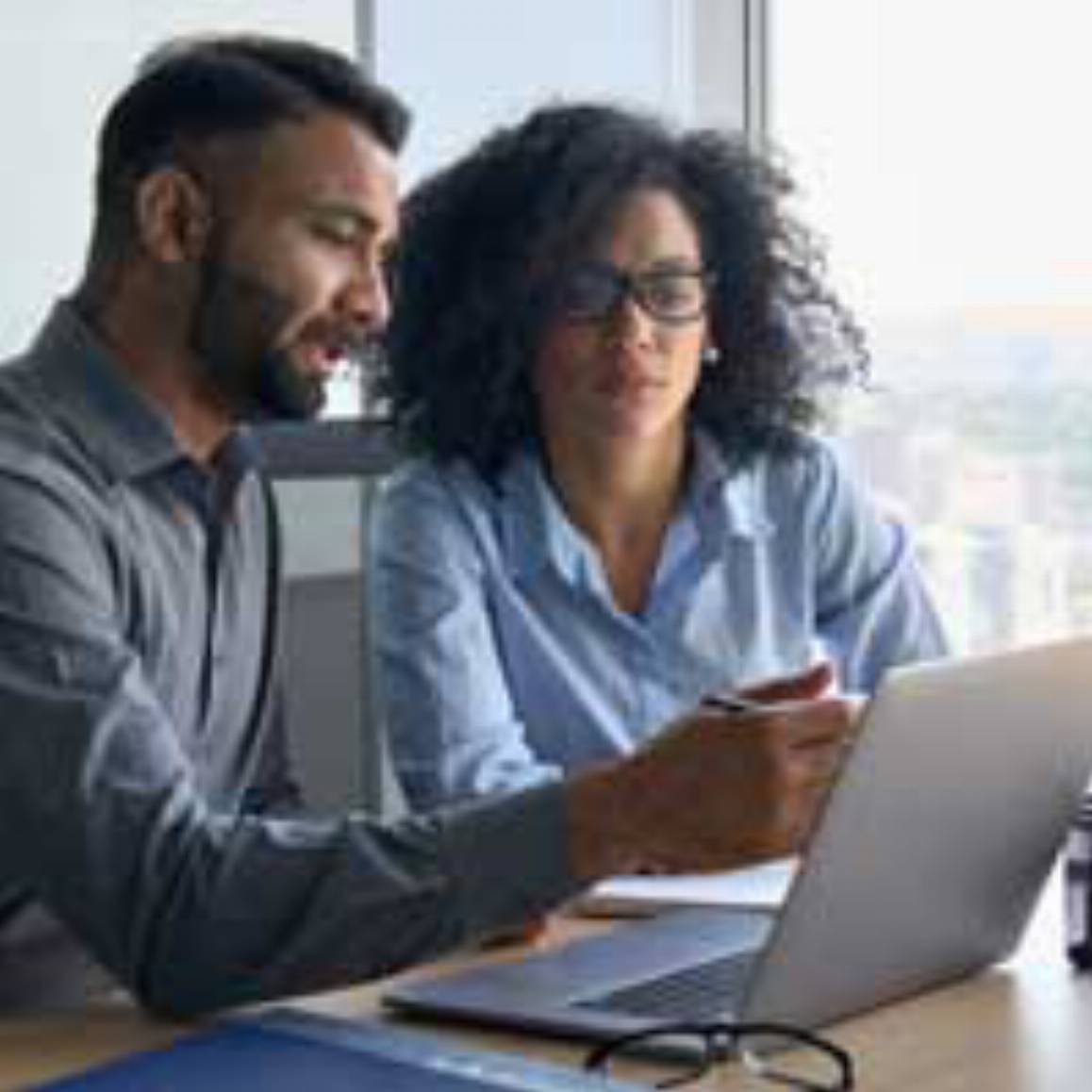 man and woman looking at a laptop computer