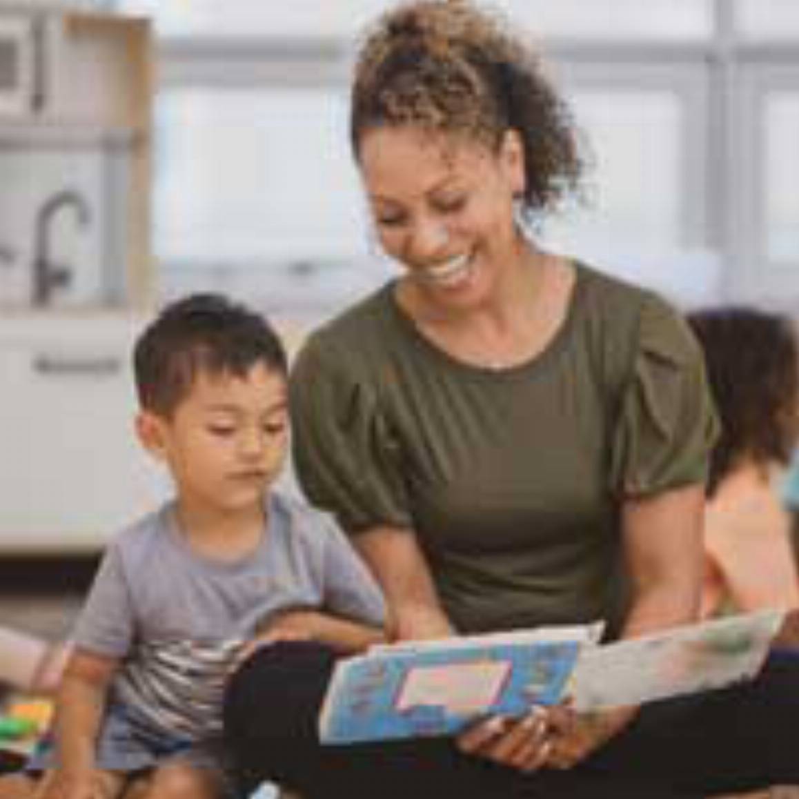 woman reading a book with a child