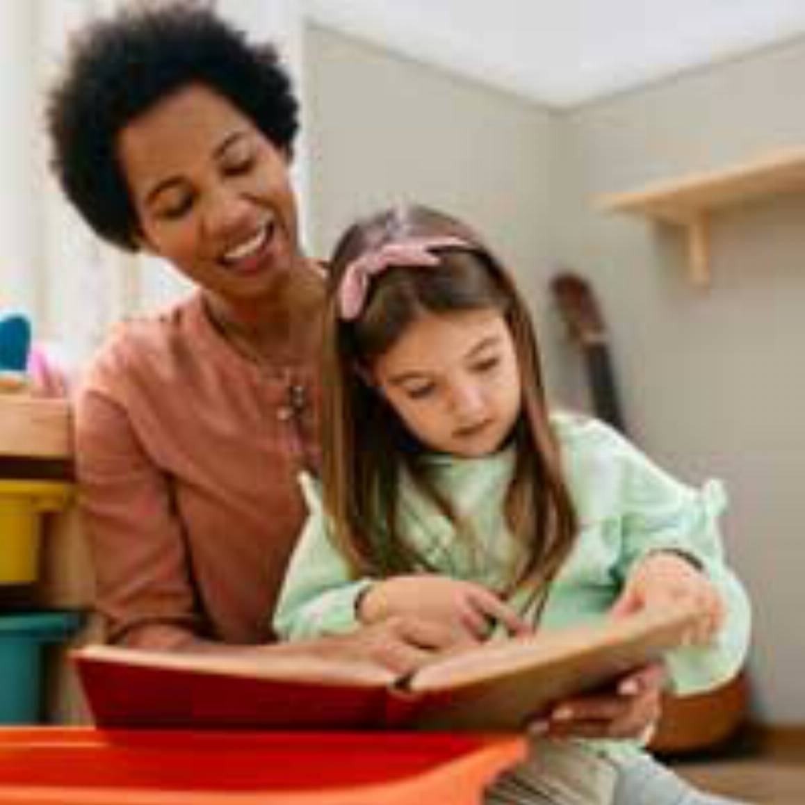 woman reading a book with a child