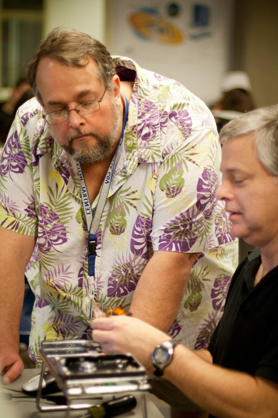 Edmonds College has offered hands-on training from nationally recognized experts in cybersecurity and digital forensics since 1999. Instructor Steven Hailey (standing) assists Trey Werner in repairing a hard drive. (Photo Credit: Steve Hailey)