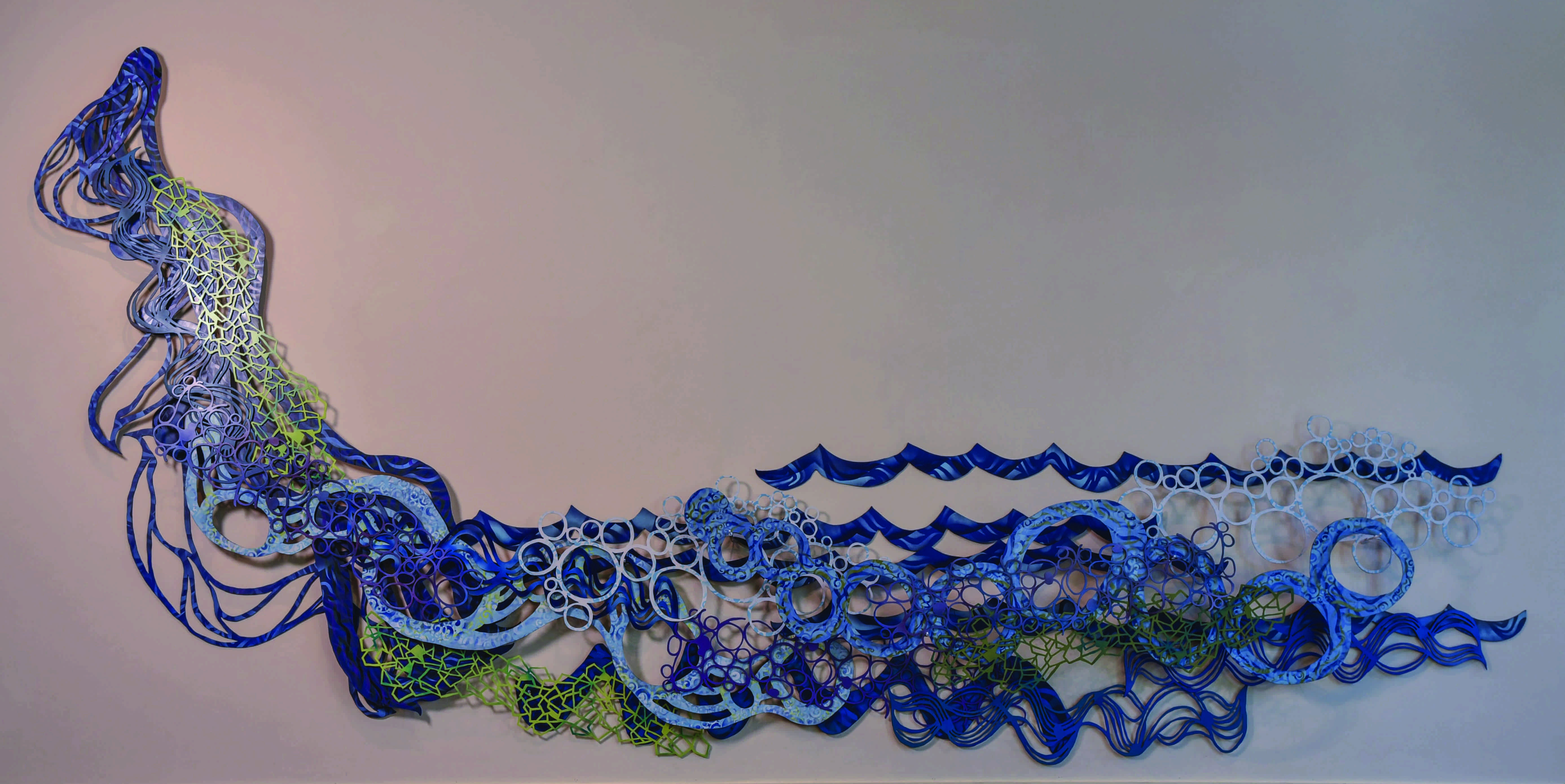 River Run,” a sculpture by artist June Sekiguchi, is made of enamel on scroll cut hardboard.
