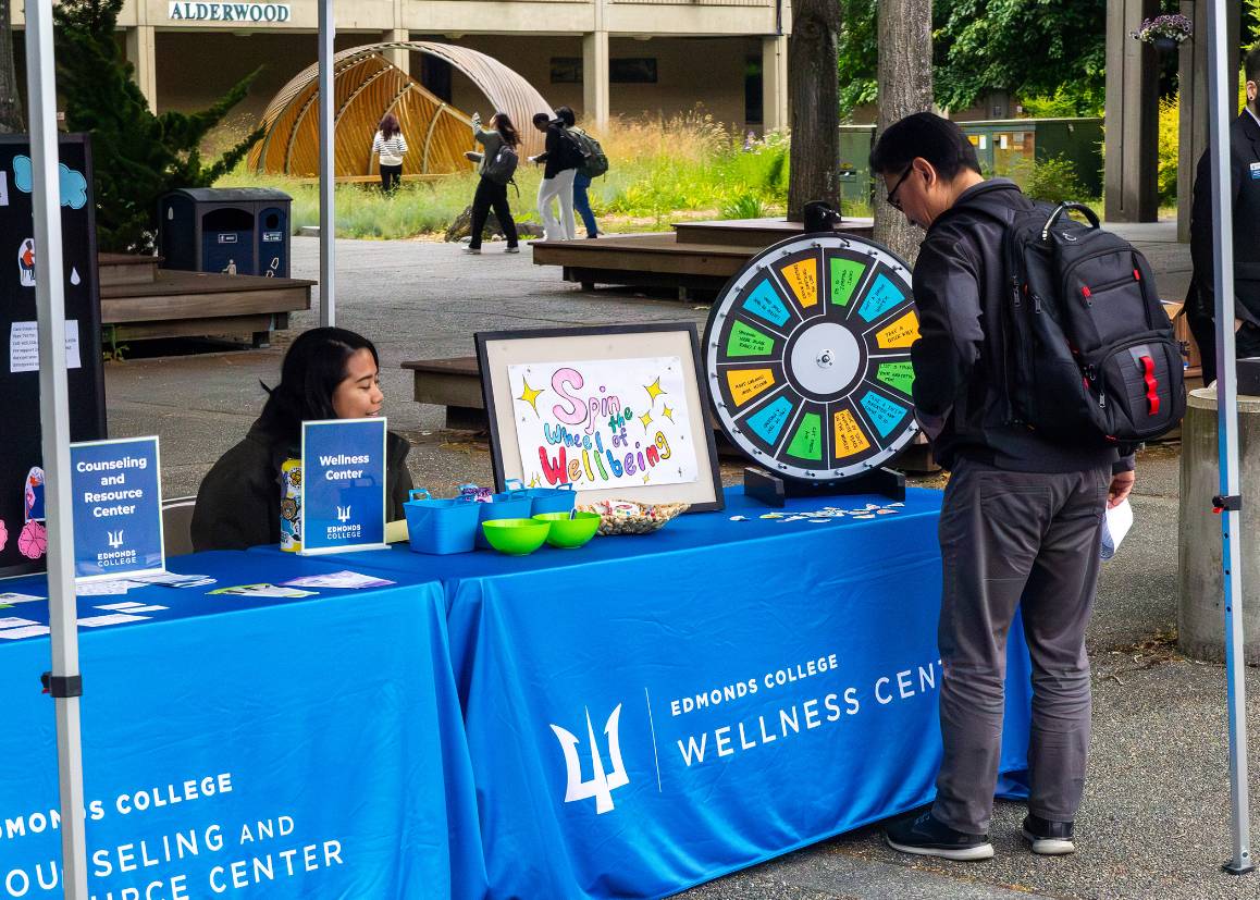 A student visits the Wellness Center table during Edmonds College&rsquo;s Triton Visit Day. (Photo by Miranda Shook/Edmonds College)