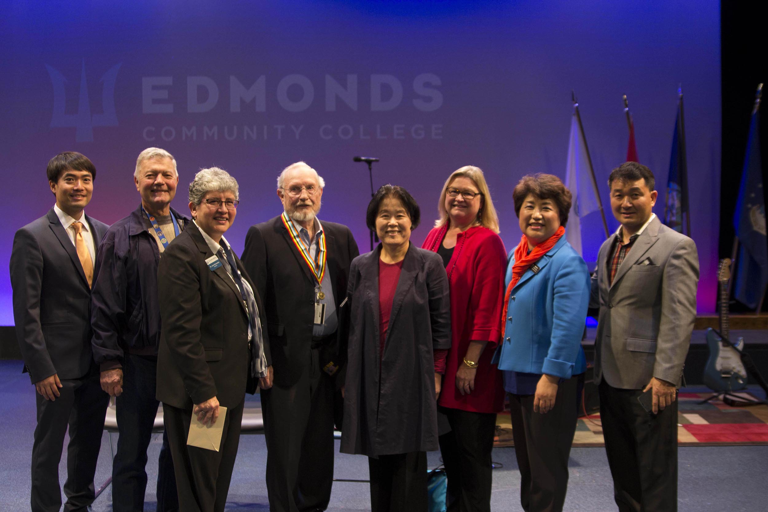 (from left to right) Sun K. Lee, Edmonds CC alumnus and veteran Steve Pennington, Edmonds CC President Dr. Jean Hernandez, Ambassador for Peace medal recipient Paul Poppe, guest, city of Lynnwood Mayor Nicola Smith, Washington state Rep. Cindy Ryu, and Ki Seung Cho.