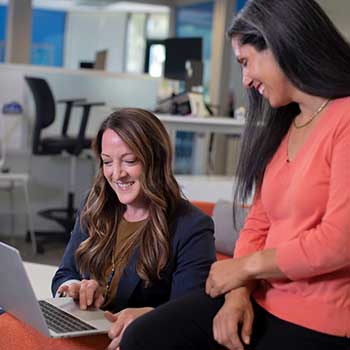 Two women using a laptop