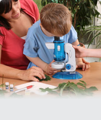  Child and teacher looking through microscope