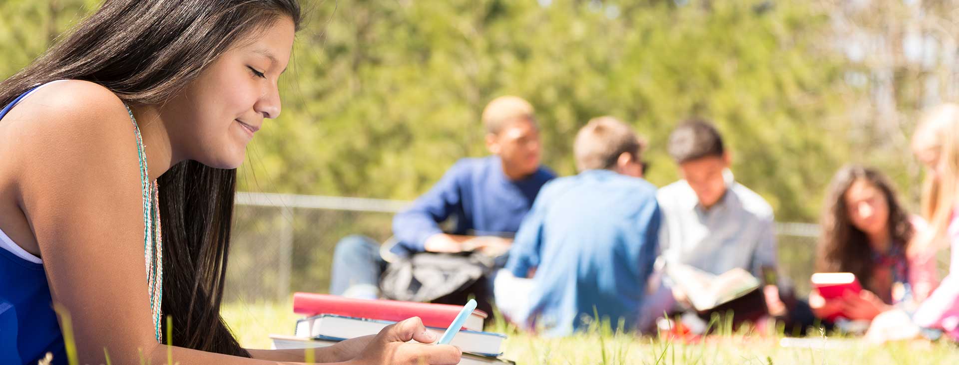 Indigenous student on the studying on the grass