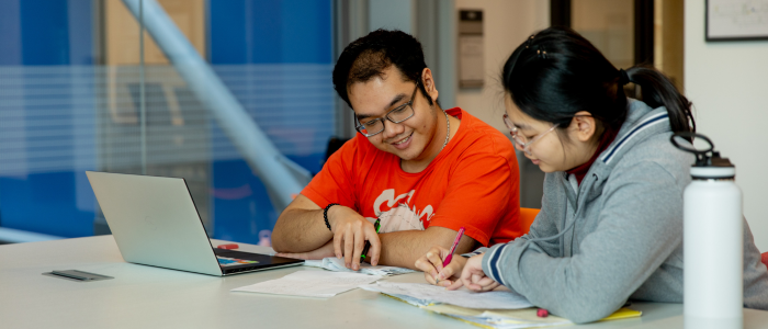 Two students studying together at table