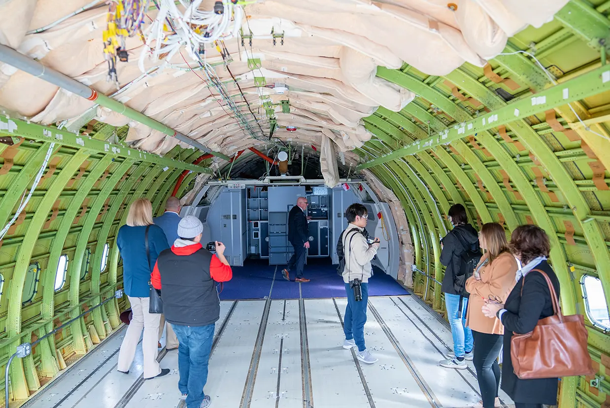 AMSC Executive Director Larry Cluphf leads media and SME staff through a Boeing 767 fuselage