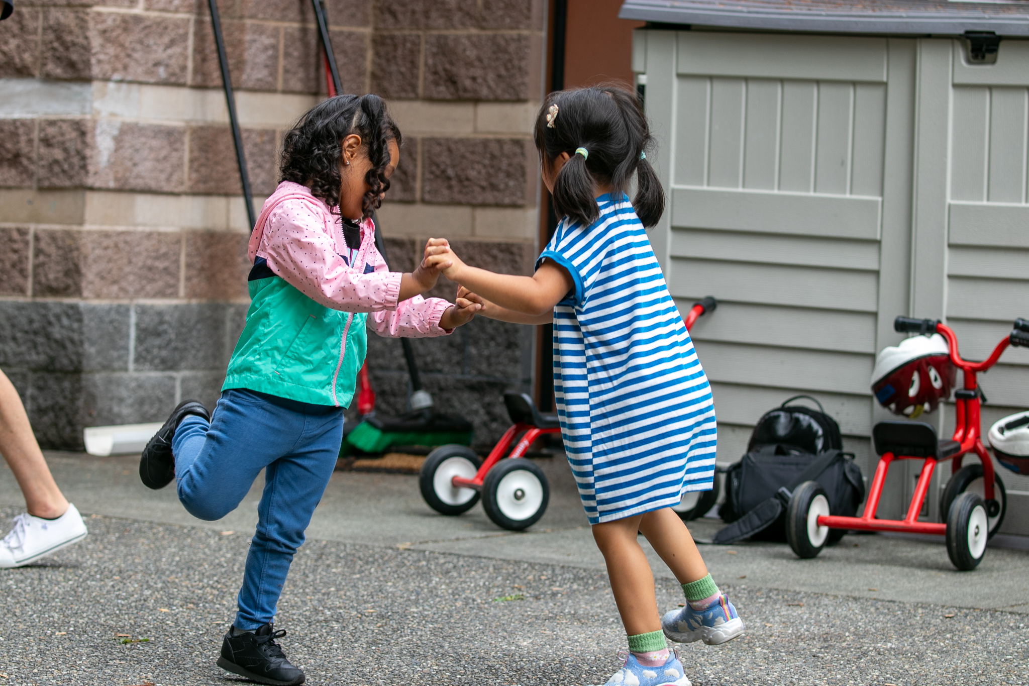 Two pre-school students playing in the courtyard at the Center for Families at Edmonds College.
