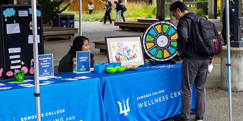 A student visiting the Wellness Center table during the resource fair at Triton Visit Day in 2025. 