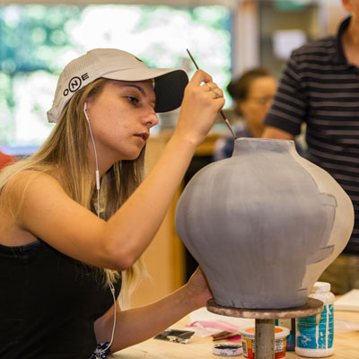 Student in pottery class