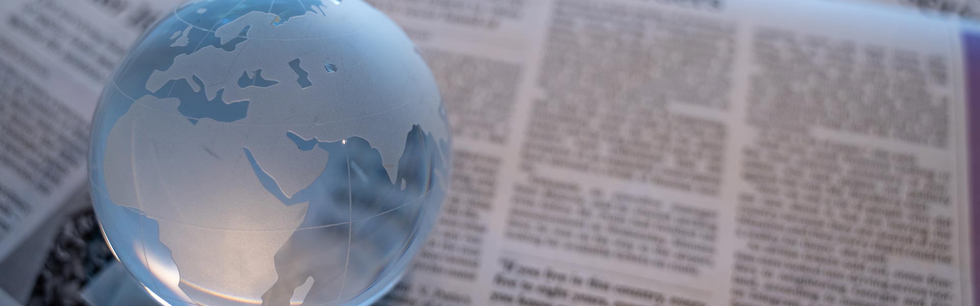 Glass globe and newspaper