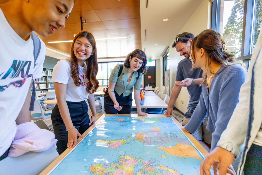 English learners looking at a world map