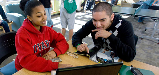 Students looking at a computer