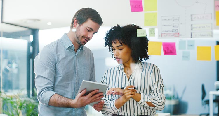 Man and woman looking at a tablet