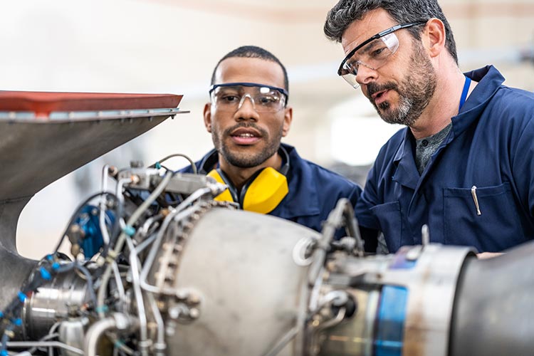 student and instructor working on jet engine