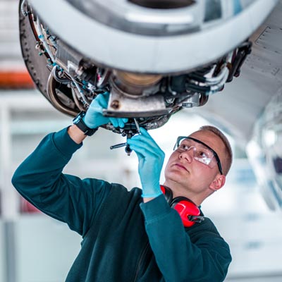 man working on jet engine