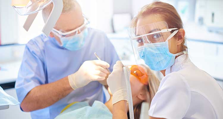 Dental assistant working with the dentist