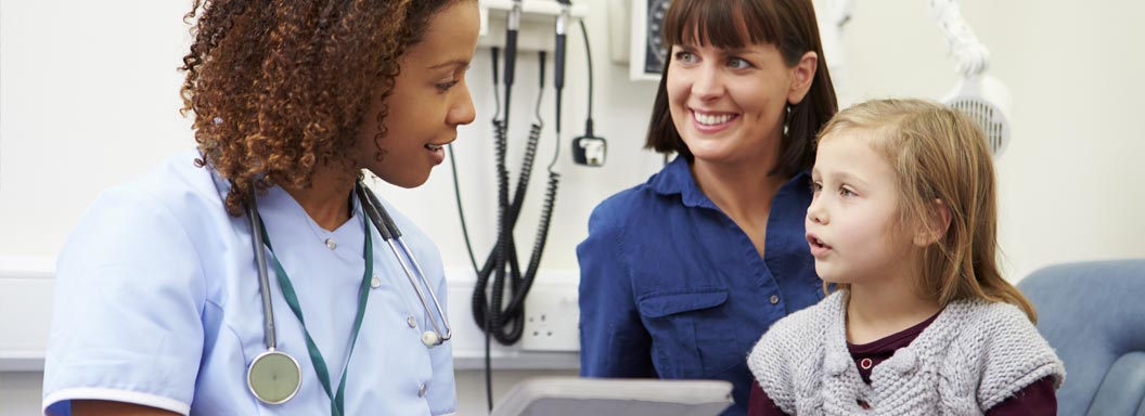 Medical assistant working with patient