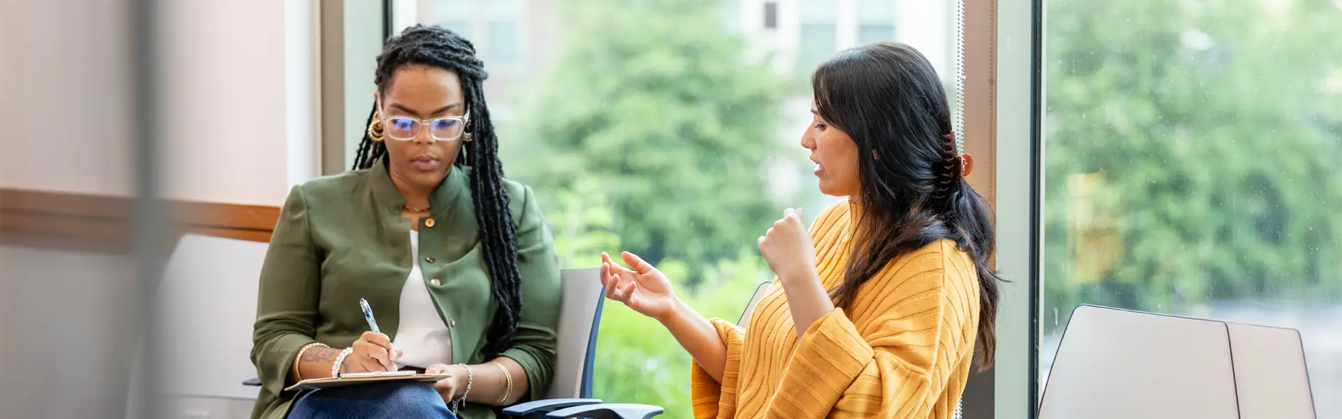 Counselor listen to client and taking notes.
