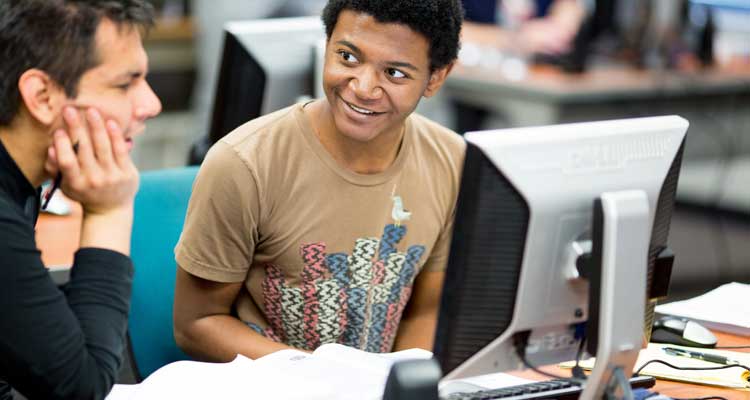 Two students talking in the computer lab