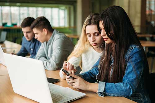 Students looking at a computer