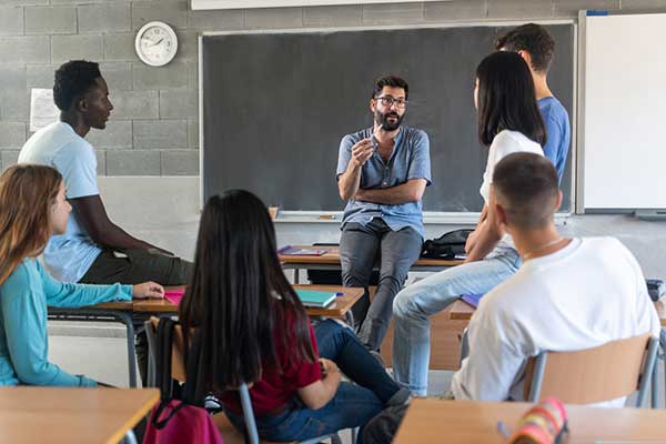 Teacher talking with High School students