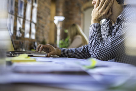 man sitting behind a desk in modern office