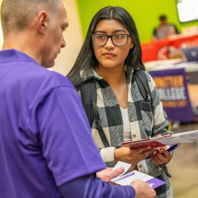 student talking to a univerity representative