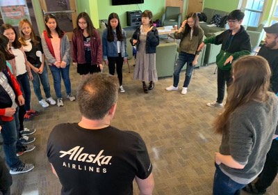 Housing Ambassador Meeting with several students conversing in a circle