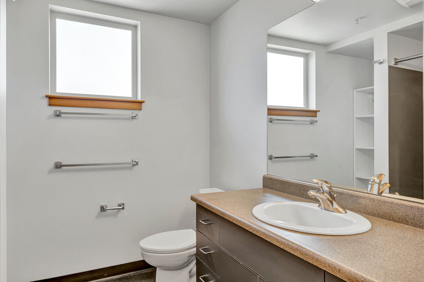 a photo of the bathroom, showing a vanity and a toilet