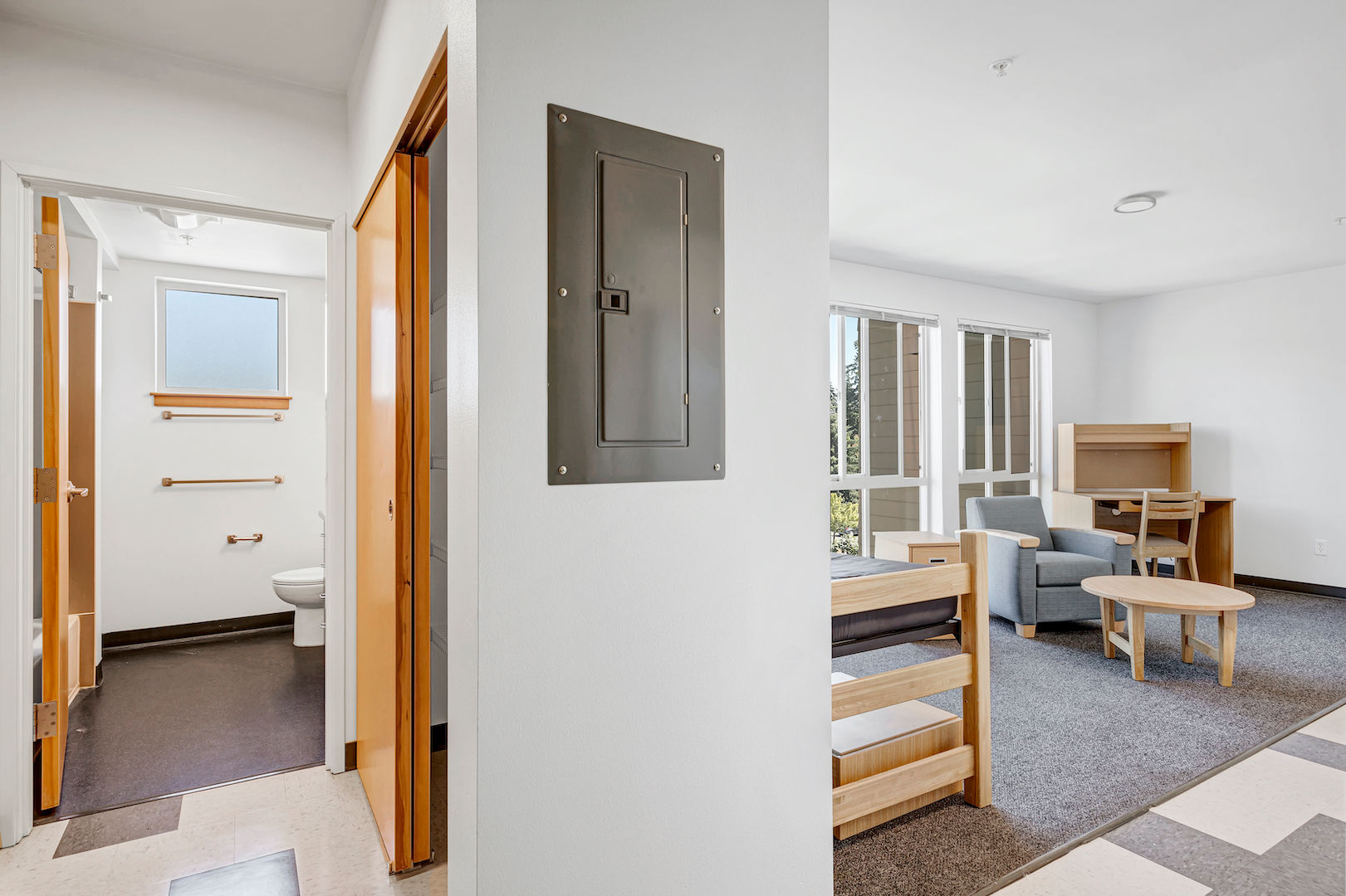 Entrance to a studio unit in Rainier Place, showing both the hallway leading to the bathroom and the main living space