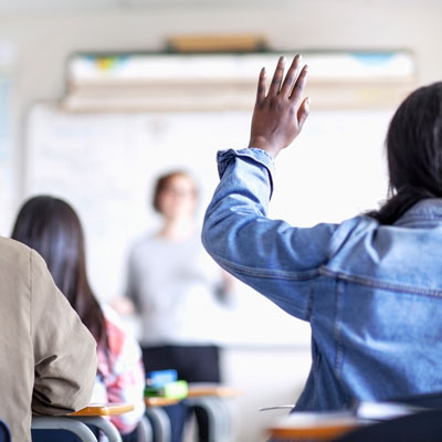 student raising a hand in class