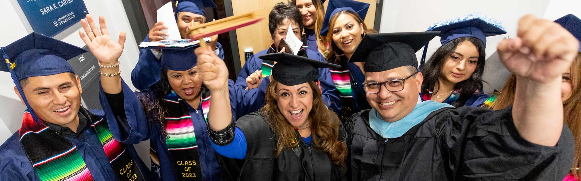 Graduates and faculty celebrating